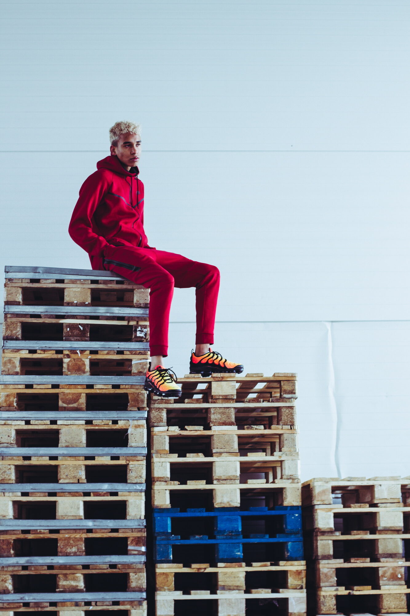 Joshua Arthur (JJDREAMSS) · 2018 — Up on the crates in a storage unit, blonde, in the red Nike track that turns up again years later in the documentary