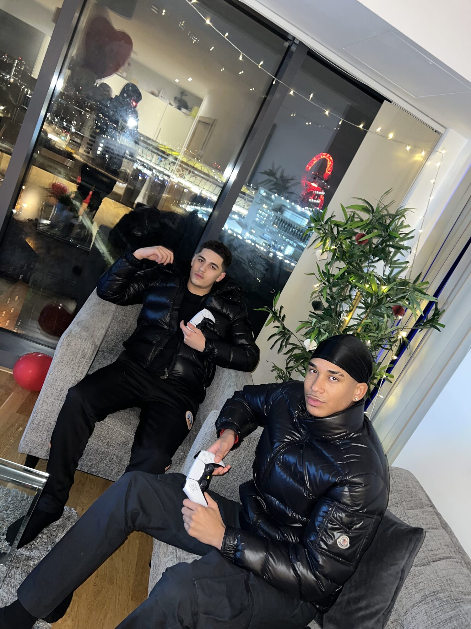 Joshua Arthur (JJDREAMSS) — Two PS5 controllers, a sofa and a skyline